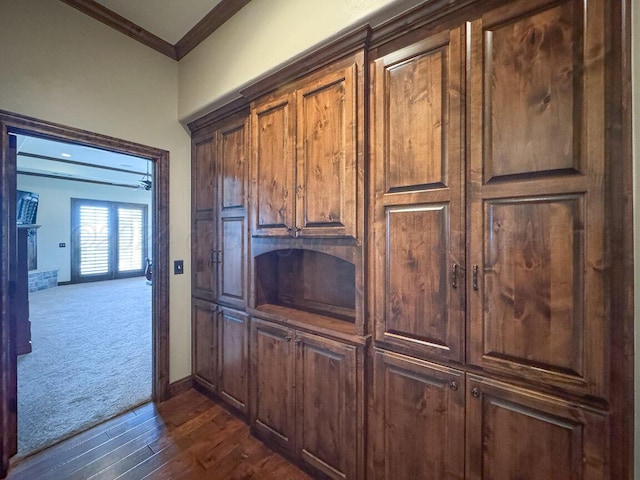2501 Mackenzie Trl, Amarillo, TX 79124 - kitchen featuring dark colored carpet, dark wood-type flooring, baseboards, and ornamental molding