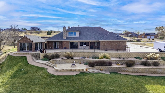 2501 Mackenzie Trl, Amarillo, TX 79124 - back of property featuring brick siding, an outdoor fire pit, a chimney, a yard, and a patio