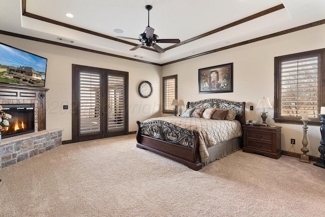 2501 Mackenzie Trl, Amarillo, TX 79124 - carpeted bedroom with crown molding, baseboards, a glass covered fireplace, a raised ceiling, and access to outside