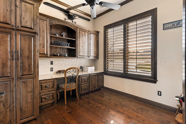2501 Mackenzie Trl, Amarillo, TX 79124 - office area featuring dark wood-type flooring, ornamental molding, built in desk, baseboards, and ceiling fan