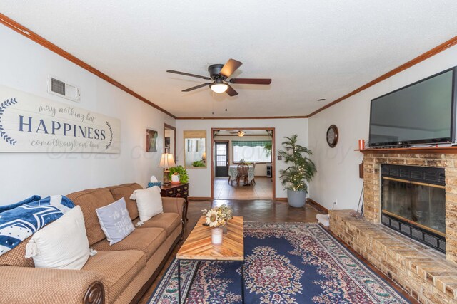2041 S Travis St, Amarillo, TX 79109 - living area featuring crown molding, a ceiling fan, and a fireplace