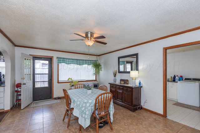 2041 S Travis St, Amarillo, TX 79109 - dining area featuring washer / dryer, healthy amount of natural light, ceiling fan, ornamental molding, and arched walkways
