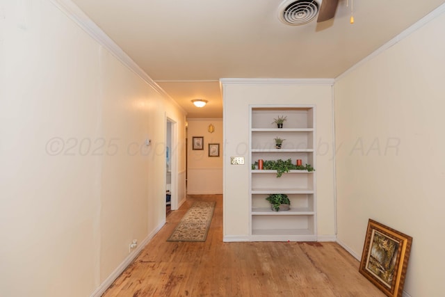 2041 S Travis St, Amarillo, TX 79109 - hall featuring light wood finished floors, built in shelves, and crown molding