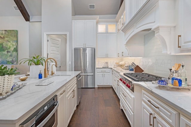 kitchen featuring stainless steel appliances, white cabinets, and sink