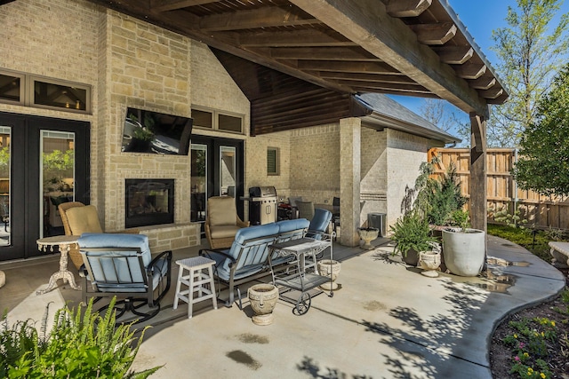 view of patio / terrace with a grill and a fireplace