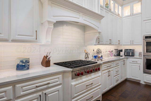 kitchen featuring white cabinetry, backsplash, and stainless steel appliances