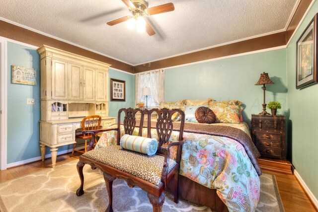 5200 Kingswood Cir, Amarillo, TX 79109 - bedroom with a textured ceiling, crown molding, light wood finished floors, and ceiling fan