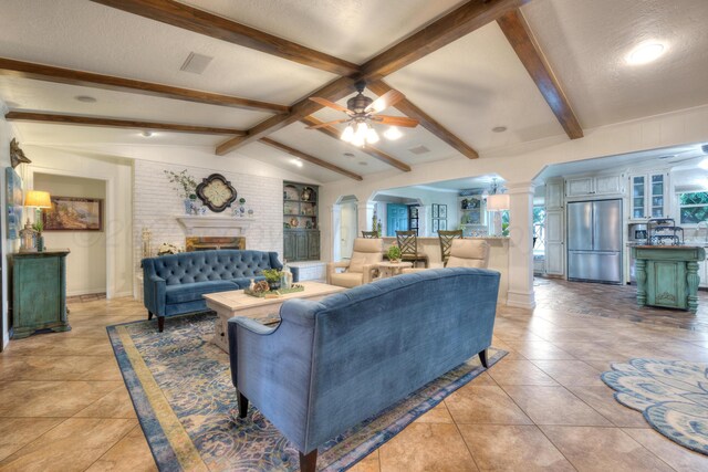 5200 Kingswood Cir, Amarillo, TX 79109 - living area with arched walkways, decorative columns, a ceiling fan, a fireplace, and light tile patterned flooring