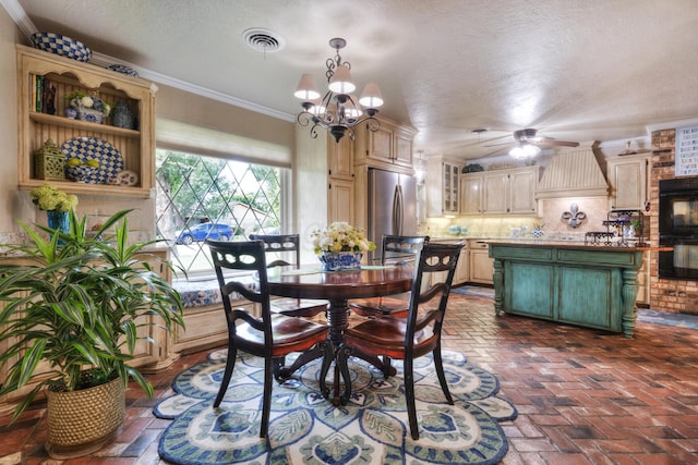 5200 Kingswood Cir, Amarillo, TX 79109 - dining room with brick flooring, ceiling fan, ornamental molding, a chandelier, and a textured ceiling