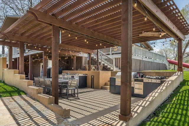 view of patio featuring a pergola, outdoor dining area, and an outdoor kitchen