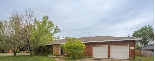 3414 S Austin St, Amarillo, TX 79109 - ranch-style home featuring concrete driveway, an attached garage, brick siding, and a front lawn