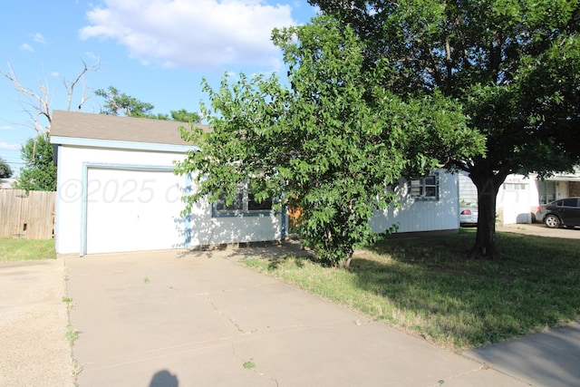 1035 Bagarry St, Amarillo, TX 79104 - view of property hidden behind natural elements with concrete driveway and an attached garage