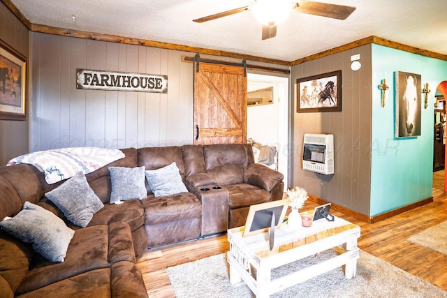 713 N Dwight St, Pampa, TX 79065 - living room with ceiling fan, a barn door, wood finished floors, heating unit, and ornamental molding