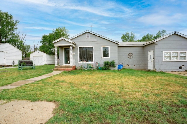 713 N Dwight St, Pampa, TX 79065 - bungalow-style house with a detached garage, an outdoor structure, and a front lawn