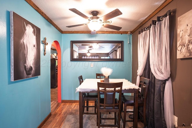 713 N Dwight St, Pampa, TX 79065 - dining area with crown molding, arched walkways, ceiling fan, and wood finished floors