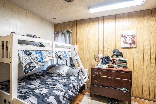 713 N Dwight St, Pampa, TX 79065 - bedroom featuring wood walls and a textured ceiling