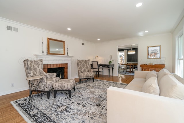 3220 S Travis St, Amarillo, TX 79109 - living area featuring wood finished floors, a brick fireplace, recessed lighting, plenty of natural light, and ornamental molding