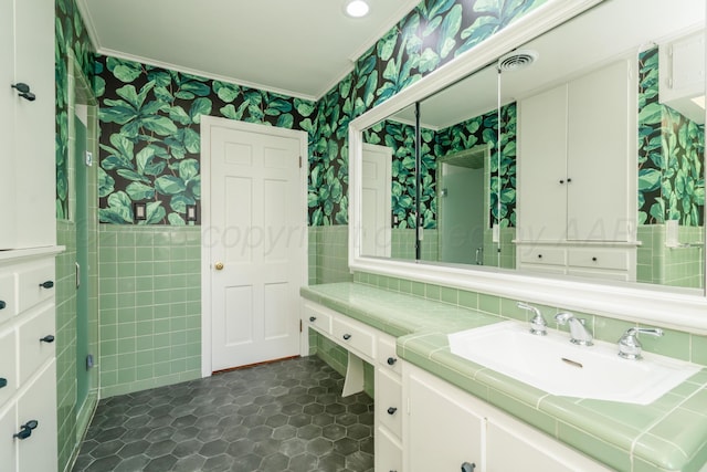 3220 S Travis St, Amarillo, TX 79109 - bathroom with wallpapered walls, crown molding, tile walls, vanity, and wainscoting