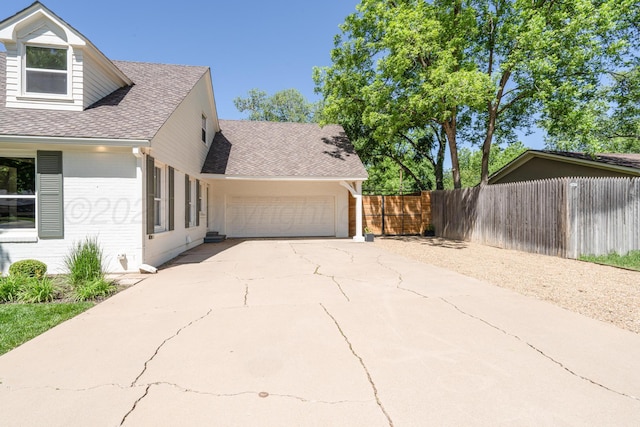 3220 S Travis St, Amarillo, TX 79109 - view of home's exterior featuring brick siding, roof with shingles, an attached garage, and driveway