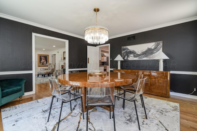 3220 S Travis St, Amarillo, TX 79109 - dining area featuring a chandelier, wood finished floors, crown molding, and baseboards