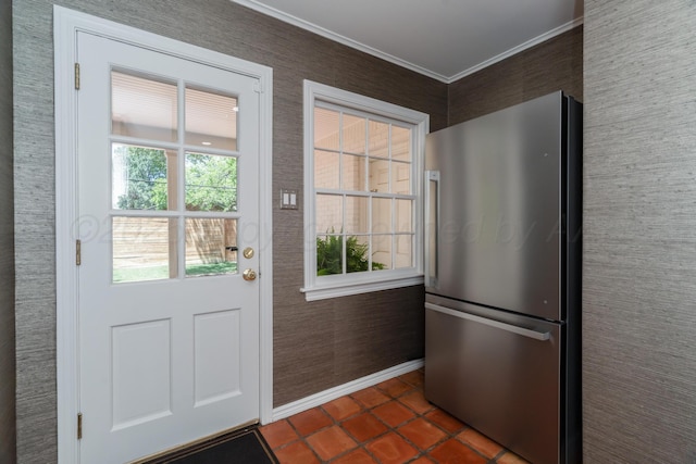 3220 S Travis St, Amarillo, TX 79109 - doorway to outside featuring crown molding, baseboards, and dark tile patterned flooring