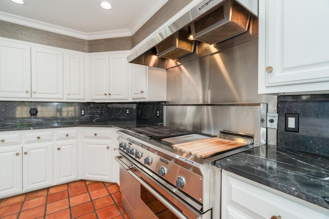 3220 S Travis St, Amarillo, TX 79109 - kitchen with high end stainless steel range oven, wall chimney range hood, decorative backsplash, white cabinets, and ornamental molding