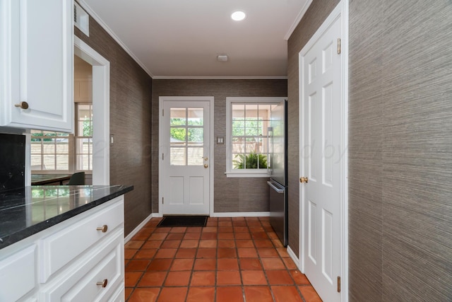3220 S Travis St, Amarillo, TX 79109 - doorway to outside featuring baseboards, crown molding, wallpapered walls, and dark tile patterned flooring