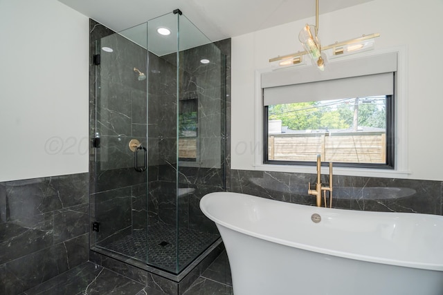 3220 S Travis St, Amarillo, TX 79109 - bathroom with a shower stall, a freestanding tub, tile walls, and marble finish flooring