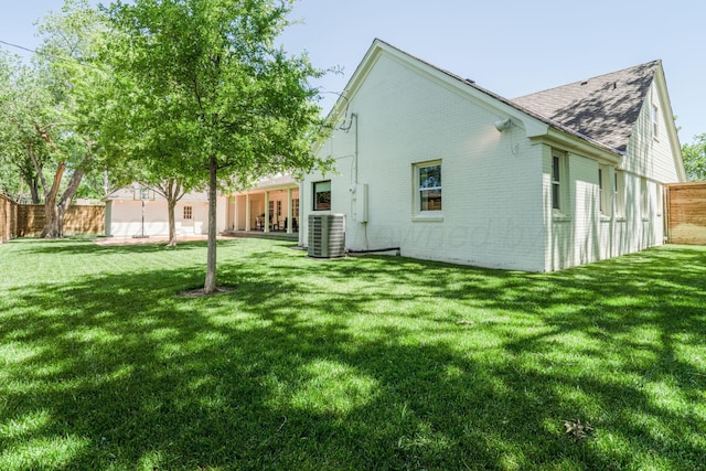 3220 S Travis St, Amarillo, TX 79109 - back of house featuring brick siding, roof with shingles, and cooling unit