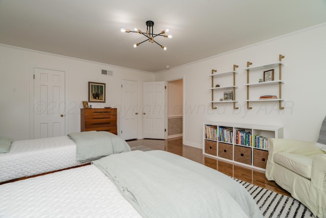 3220 S Travis St, Amarillo, TX 79109 - bedroom featuring a chandelier, wood finished floors, ornamental molding, and baseboards
