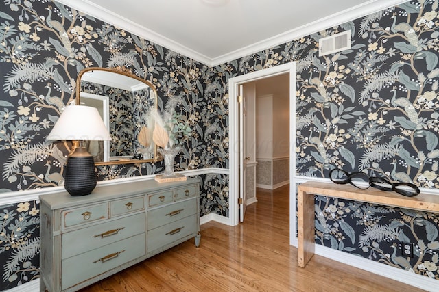 3220 S Travis St, Amarillo, TX 79109 - hall with wallpapered walls, light wood finished floors, and ornamental molding