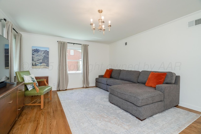 3220 S Travis St, Amarillo, TX 79109 - living area featuring light wood-style floors, a chandelier, ornamental molding, and baseboards