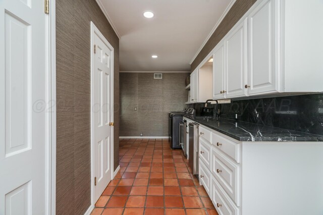 3220 S Travis St, Amarillo, TX 79109 - kitchen featuring white cabinets, washer / clothes dryer, ornamental molding, recessed lighting, and light tile patterned floors