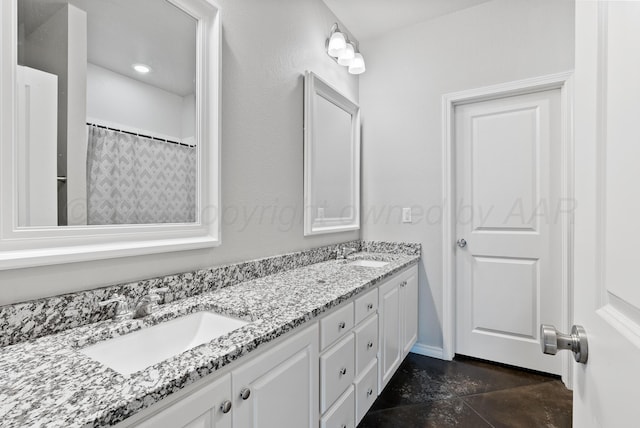 7400 Jake St, Amarillo, TX 79119 - bathroom featuring double vanity and baseboards