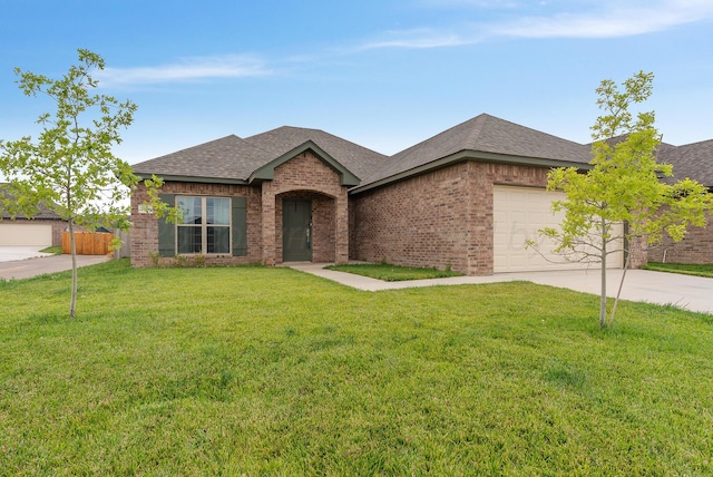 7400 Jake St, Amarillo, TX 79119 - view of front of property featuring driveway, brick siding, a garage, and a shingled roof
