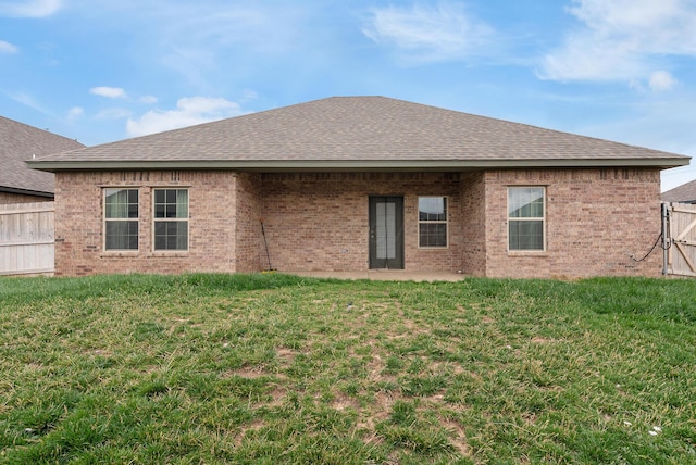 7400 Jake St, Amarillo, TX 79119 - rear view of property featuring a shingled roof, brick siding, and a patio area