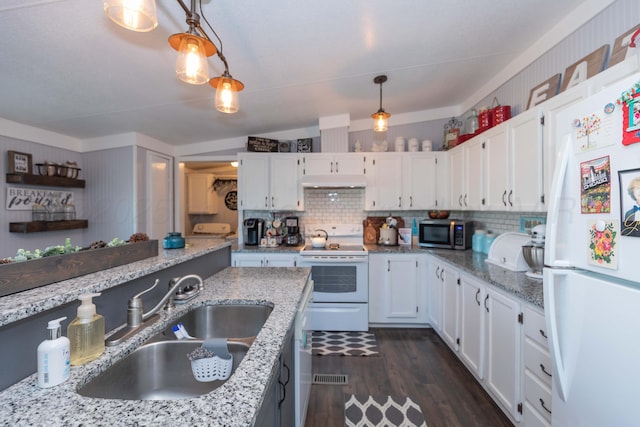 kitchen with white appliances, white cabinetry, a sink, and decorative light fixtures