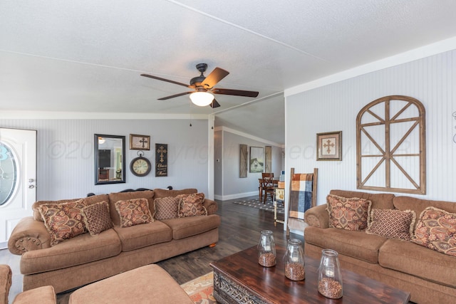 living room with baseboards, a ceiling fan, wood finished floors, and a textured ceiling
