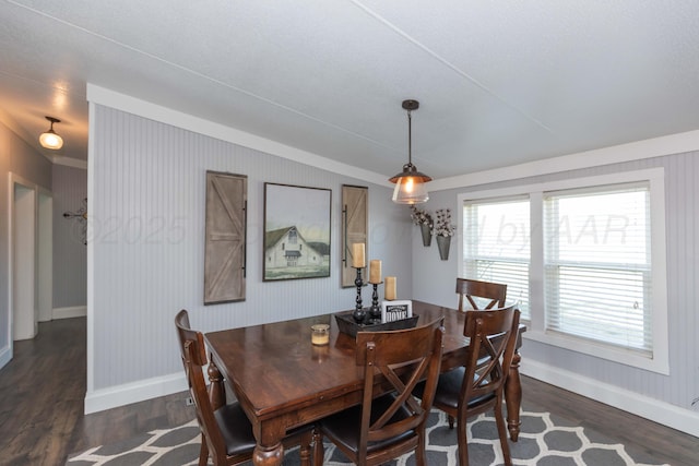 dining space with dark wood-style flooring and baseboards