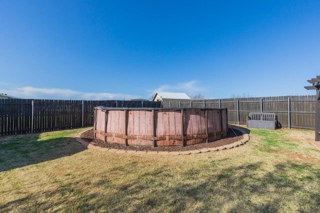 view of yard with a fenced backyard and a fenced in pool