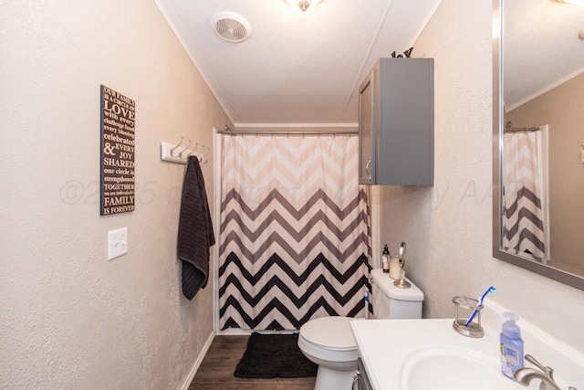 full bathroom featuring vanity, visible vents, crown molding, and wood finished floors