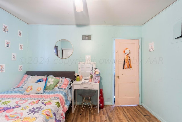 bedroom featuring hardwood / wood-style flooring and ceiling fan