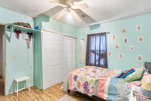 bedroom with hardwood / wood-style flooring, ceiling fan, and a closet