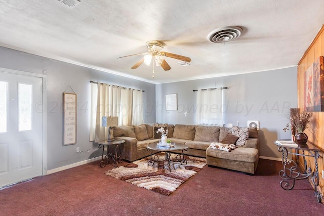 living room featuring ornamental molding, a wealth of natural light, and dark carpet