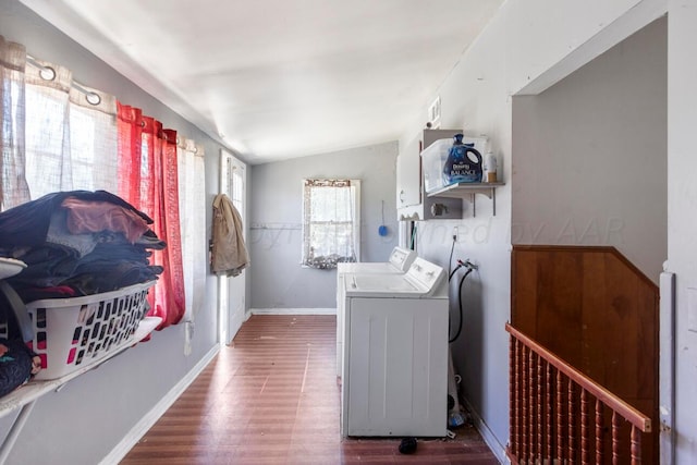 washroom with cabinets, washing machine and dryer, and dark hardwood / wood-style flooring