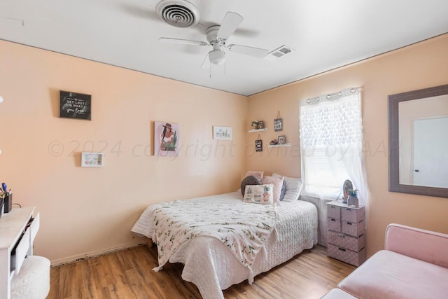 bedroom with ceiling fan and light hardwood / wood-style flooring