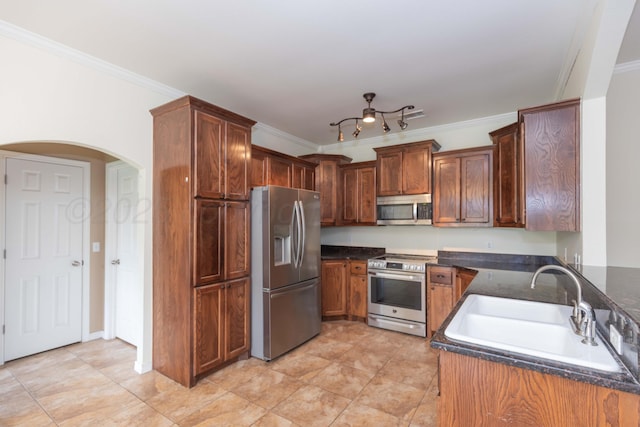 3508 Bismarck Ave, Amarillo, TX 79118 - kitchen with appliances with stainless steel finishes, a sink, ornamental molding, arched walkways, and dark stone countertops