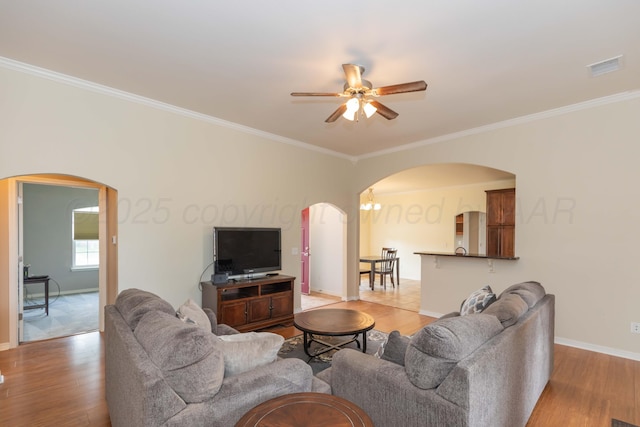 3508 Bismarck Ave, Amarillo, TX 79118 - living area featuring arched walkways, a ceiling fan, wood finished floors, baseboards, and ornamental molding