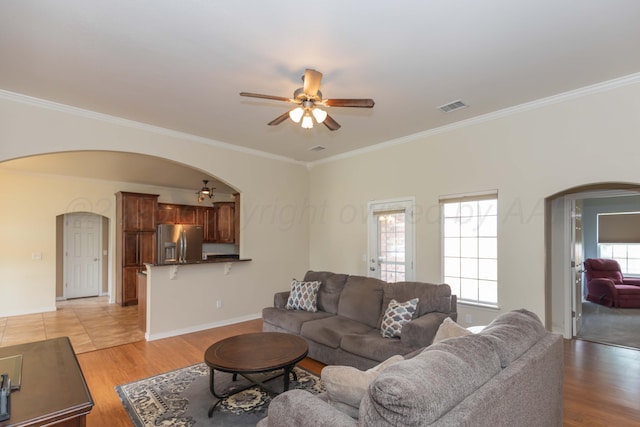 3508 Bismarck Ave, Amarillo, TX 79118 - living room with arched walkways, ceiling fan, crown molding, light wood-type flooring, and baseboards