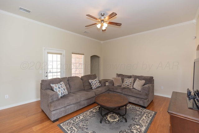 3508 Bismarck Ave, Amarillo, TX 79118 - living area with ceiling fan, crown molding, arched walkways, light wood-style flooring, and baseboards